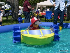 Aidan in a kid sized paddle boat.